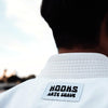 White Hooks Arte Suave BJJ Gi with label detail, showcasing the quality fabric and craftsmanship